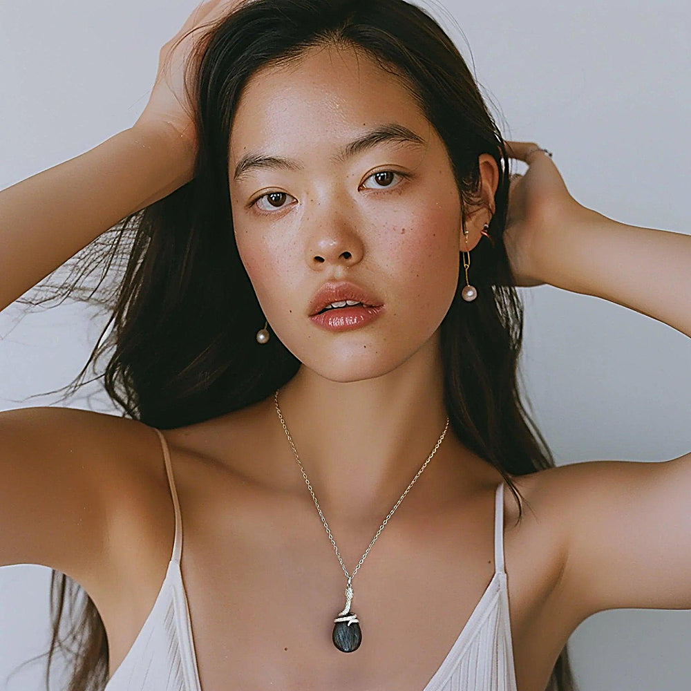 Discover the Kundalini Snake Labradorite Necklace at The Luxe Maison, featuring a coiled serpent design and mesmerizing labradorite in gold vermeil.