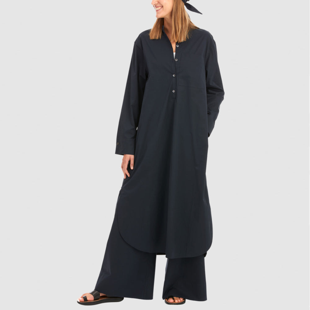 Discover the Kurta Caftan at The Luxe Maison, featuring an oversized silhouette, stand-up collar, statement pockets, and wide cuffs with mother-of-pearl cufflinks.