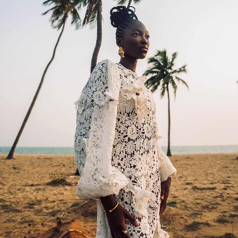 A combination of classic long denim pants paired with a meticulously hand-cut guipure lace skirt. 