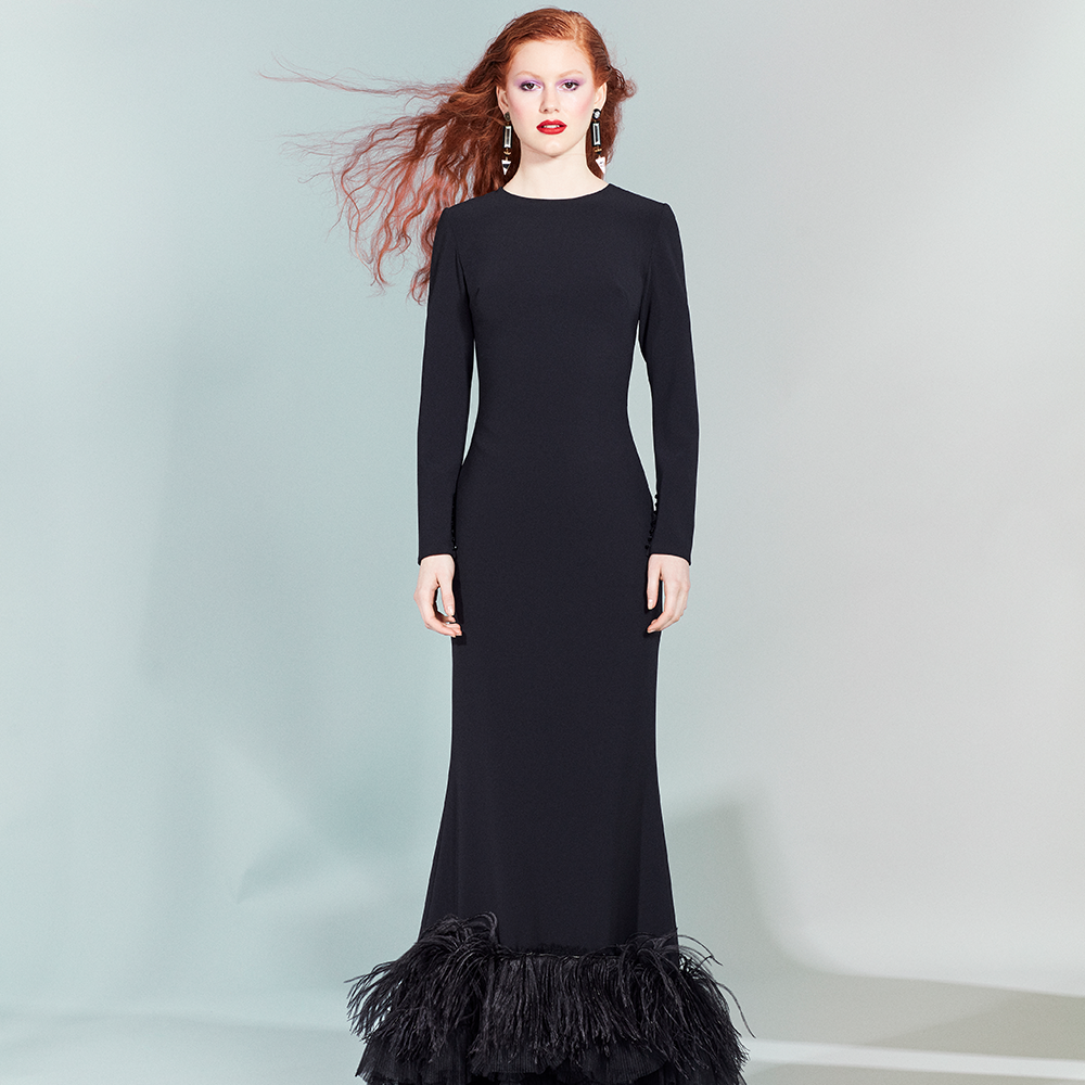 Sober and elegant black mermaid dress decorated with pleated tulle ruffles and matching ostrich feathers.