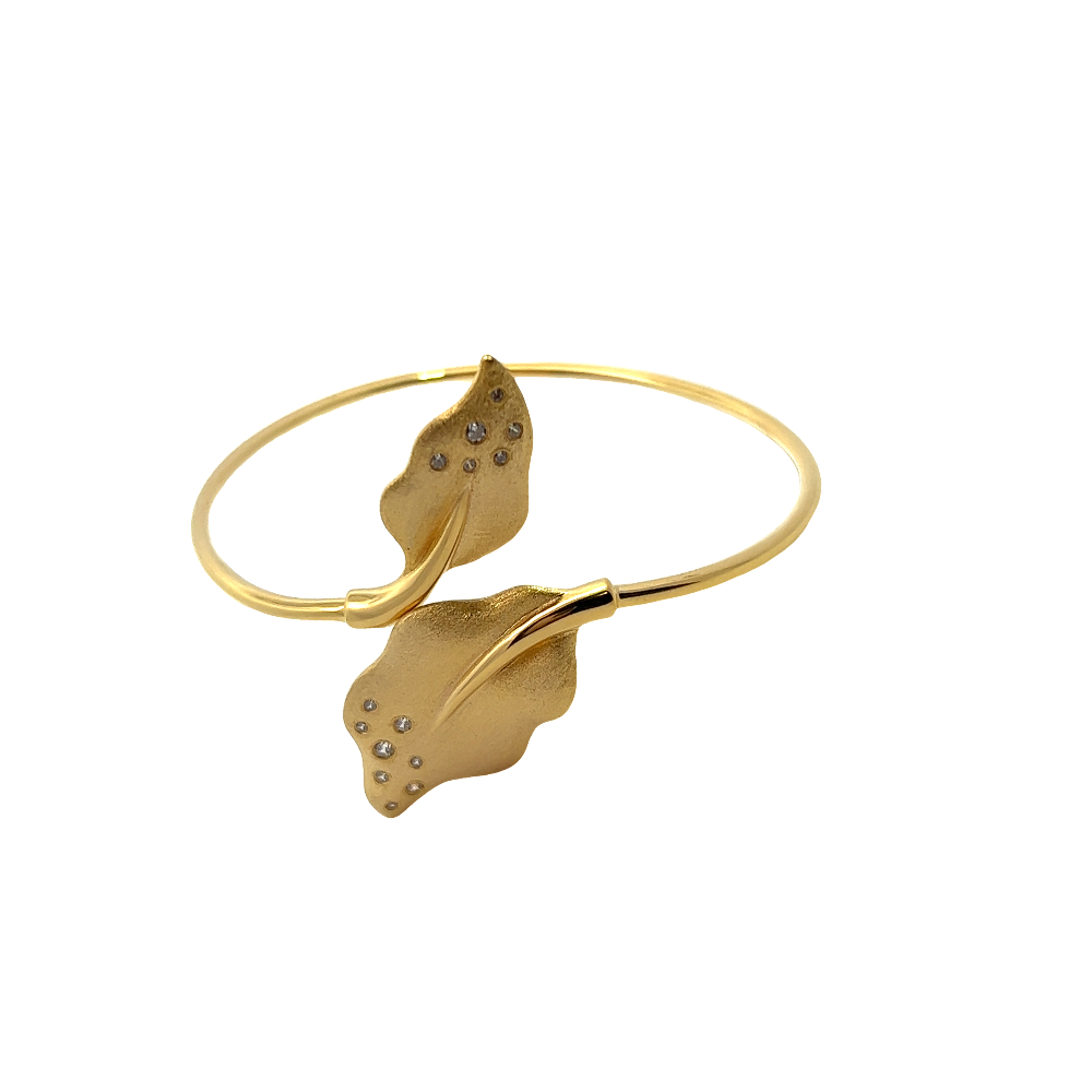 Handcrafted 18k gold-dipped sterling silver open bangle with cubic zirconia leaf accents on each side for a delicate modern statement. Shop premium jewelry online.