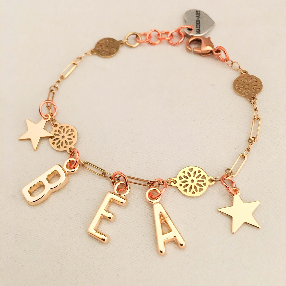 18kt gold plated letters and chain, rose gold plated brass charms. nickel-free pendant, chain, and coating.