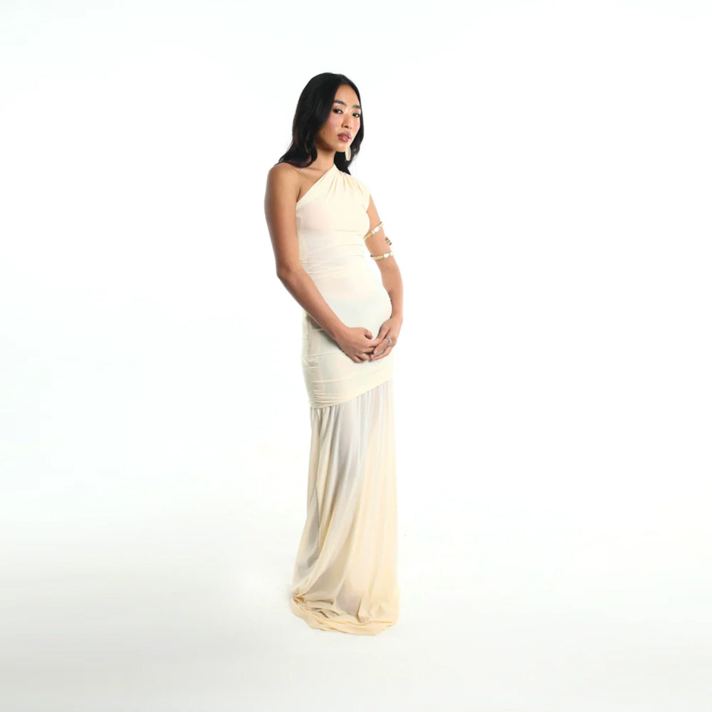 Ivory jersey dress with asymmetrical fit and gathered waist, perfect for events. Shop online from our curated edit of premium fashion.
