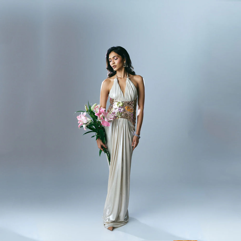 Halter maxi dress with sequin corset, floral detail, and flowy fit, perfect for events. Shop online from our exclusive collection of premium styles.