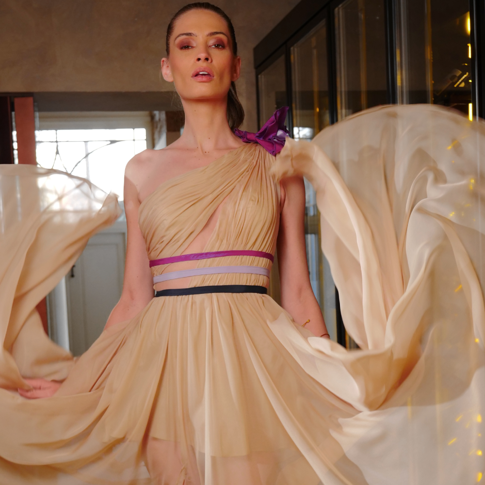 Long beige chiffon dress features tricolor belts and a shoulder flower