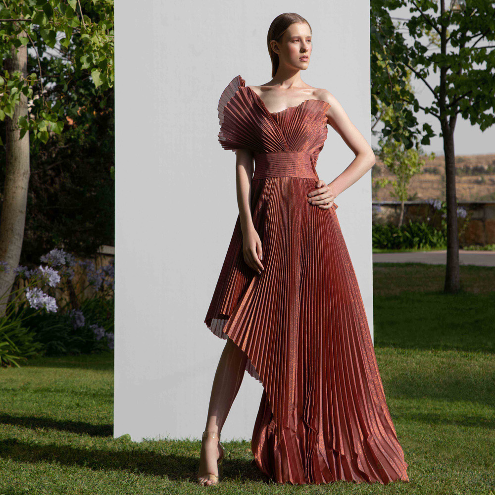 Off shoulder dress with a structural design along with a high-low pleated gown.