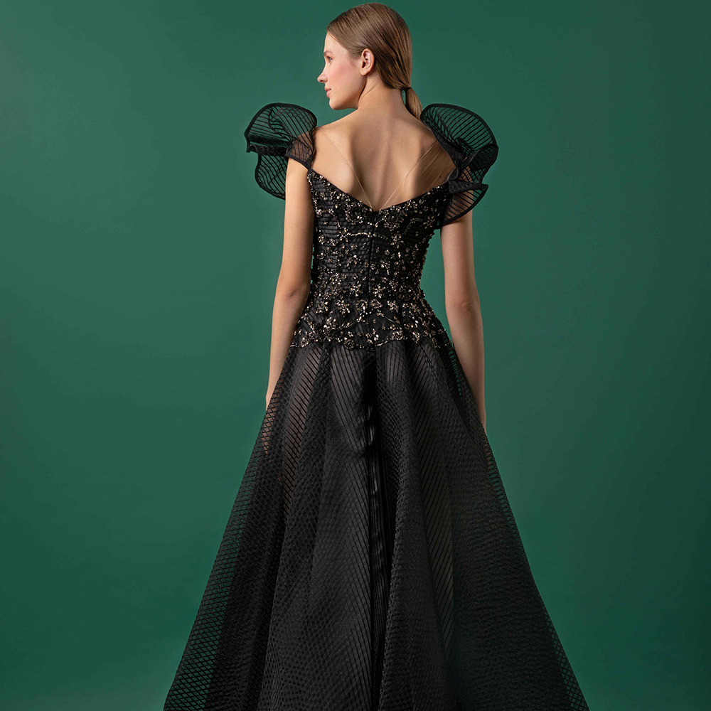 Draped shoulders surrounding a V-neck collar over a bejeweled bodice and a flared striped crain skirt.