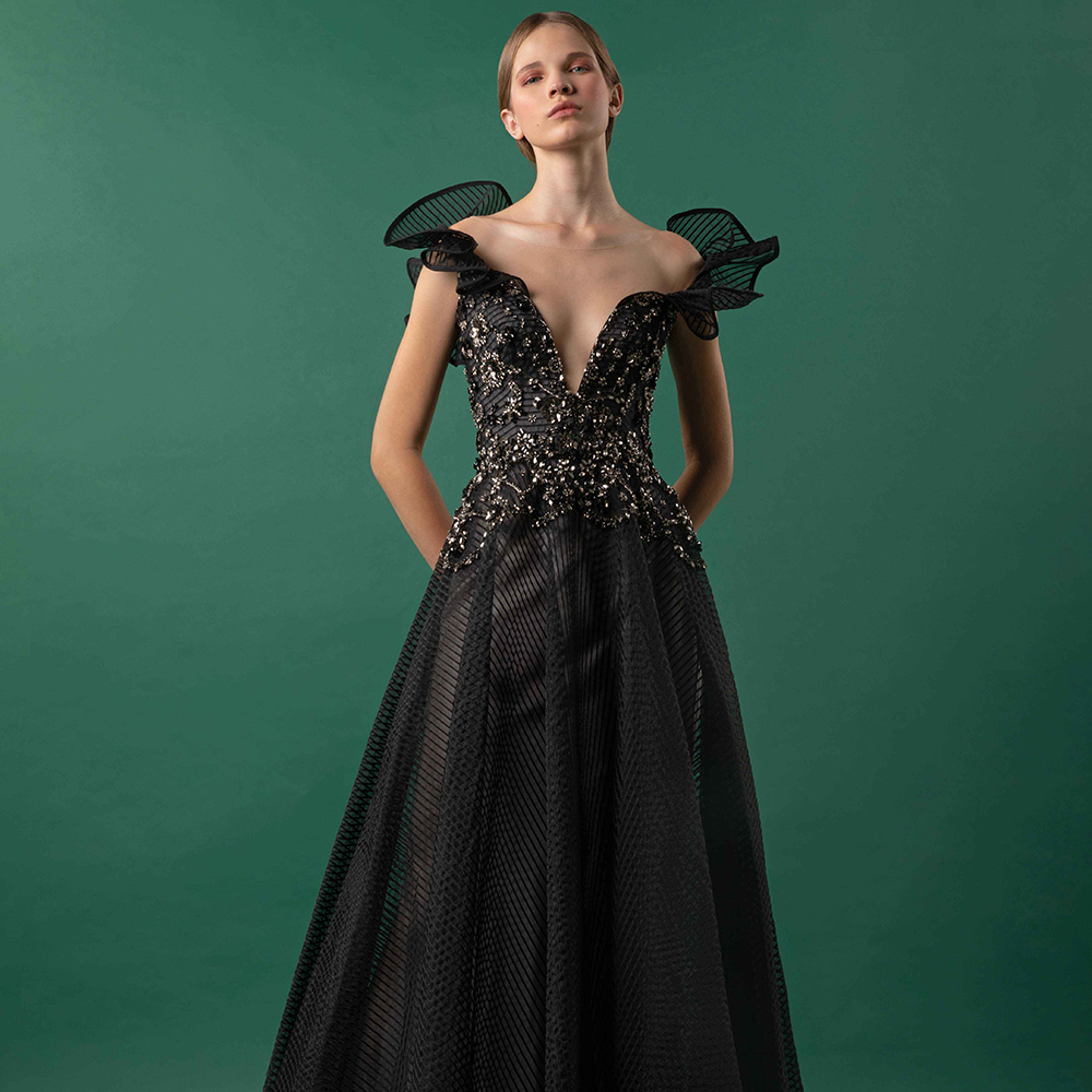 Draped shoulders surrounding a V-neck collar over a bejeweled bodice and a flared striped crain skirt.