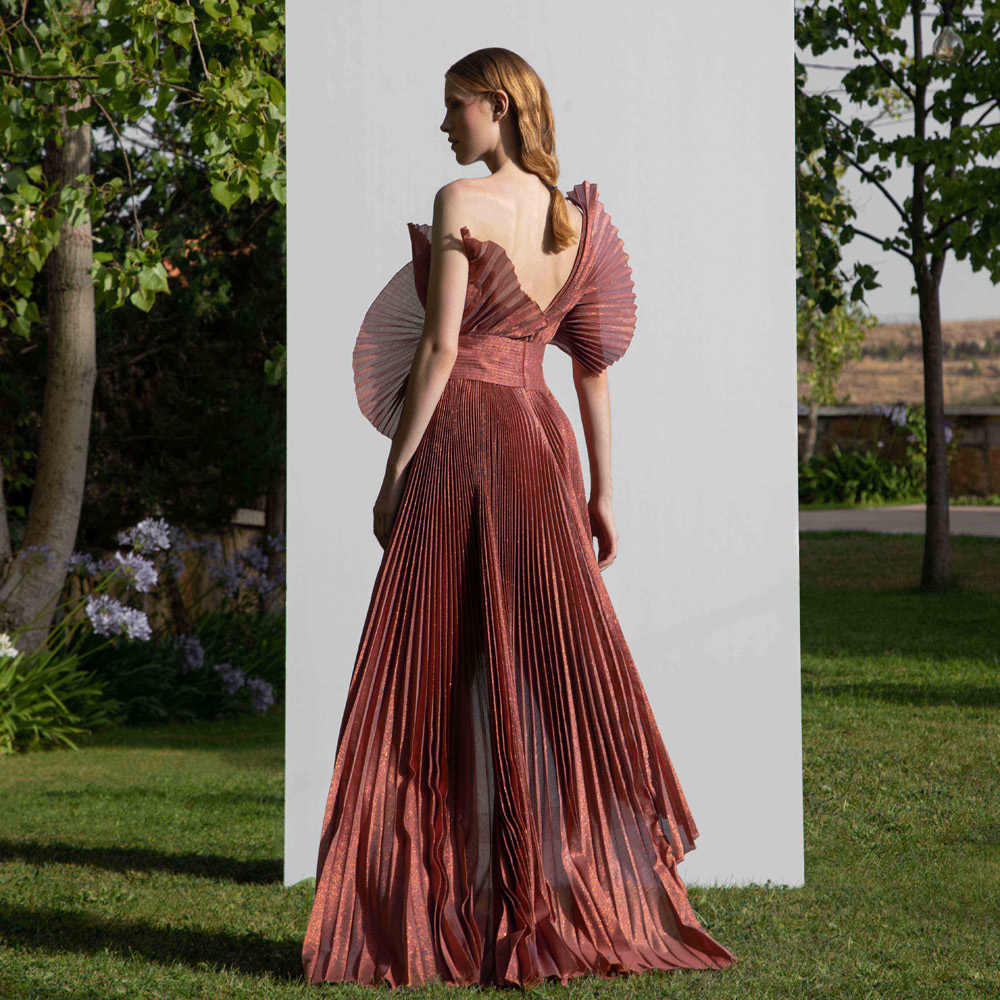 Off shoulder dress with a structural design along with a high-low pleated gown.