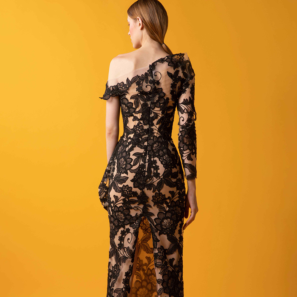 Asymmetrical off shoulder dress with floral laced fitted gown, side hip ruffle and unbalanced sleeves.