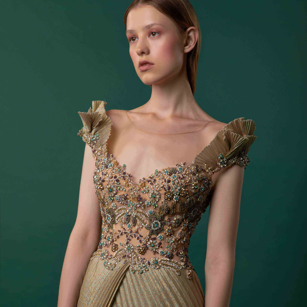 Beaded corset stitched on a pleated gown.