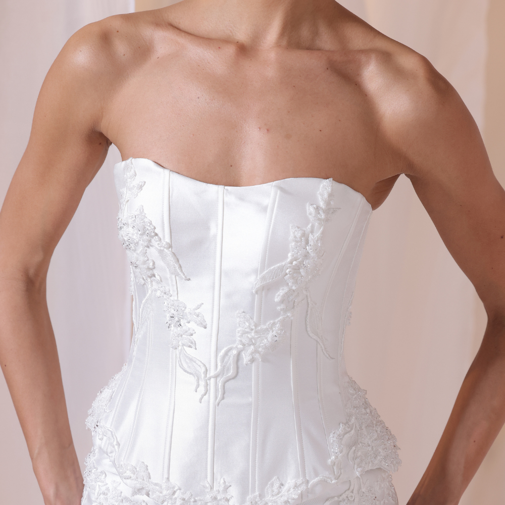Shop online refined ivory gown with structured lace corset bodice and smooth satin silhouette, perfect for weddings, parties and special occasions.