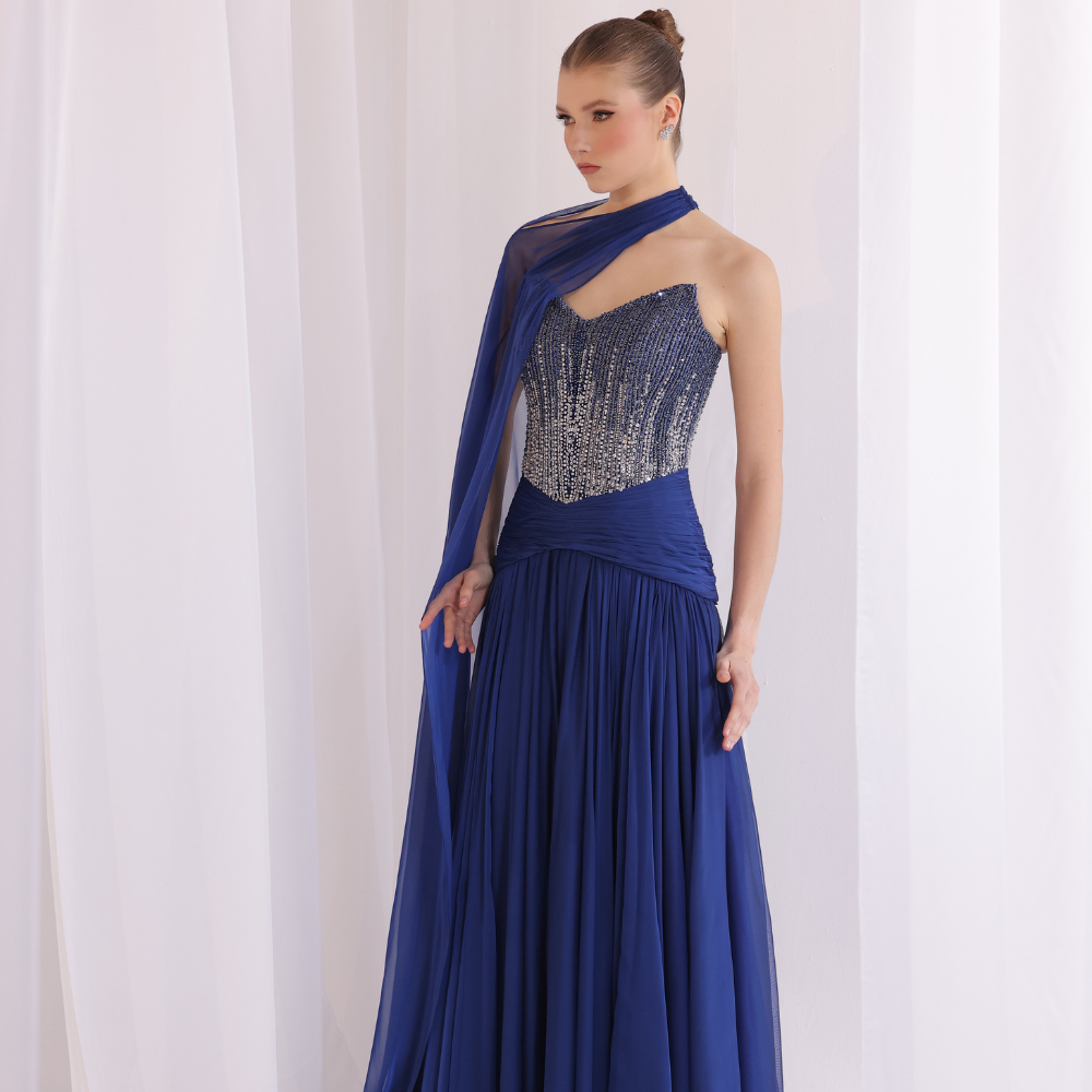 Shop online soft yellow gown with draped bodice, asymmetrical off-shoulder detail and embellished airy layers, perfect for special occasions.