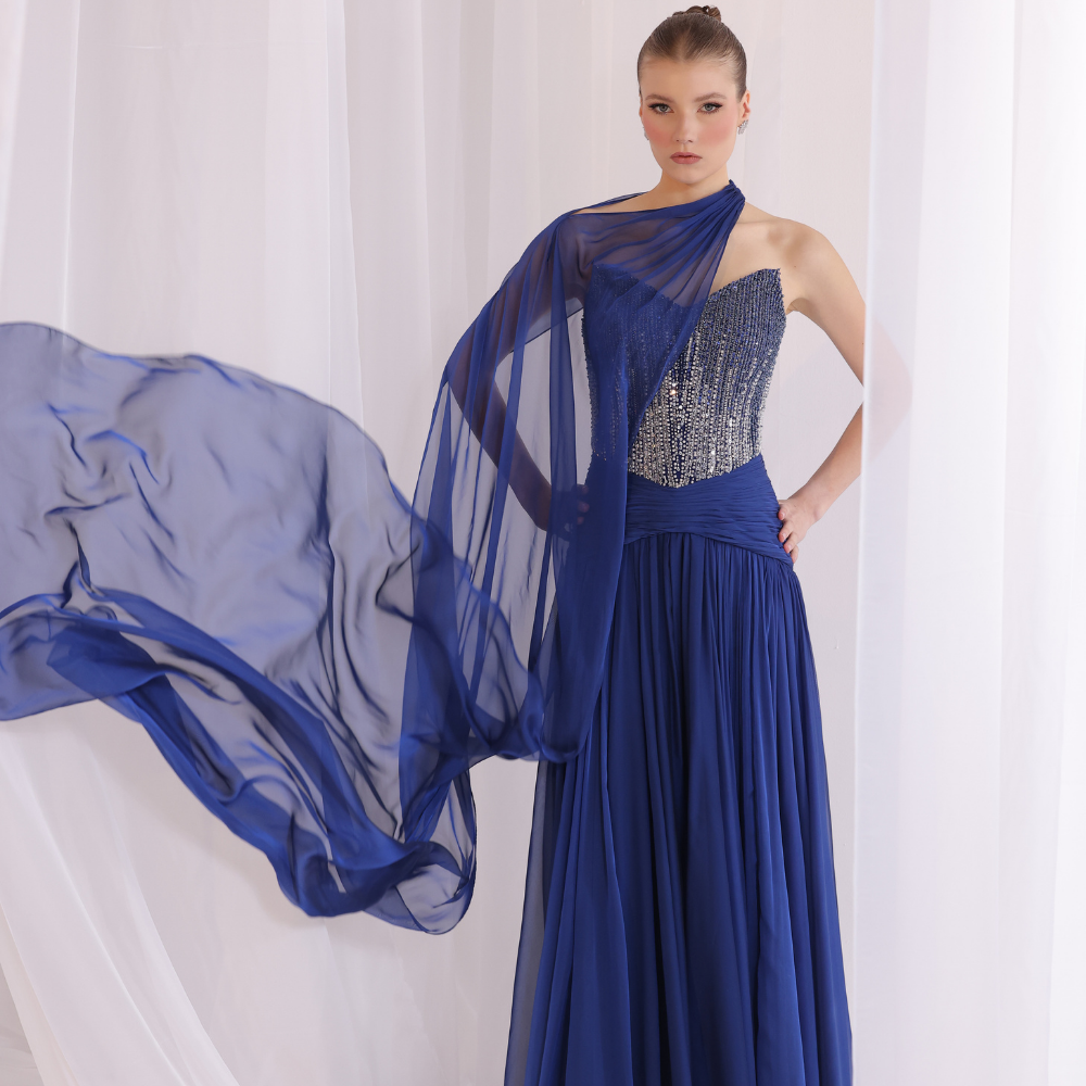 Shop online soft yellow gown with draped bodice, asymmetrical off-shoulder detail and embellished airy layers, perfect for special occasions.