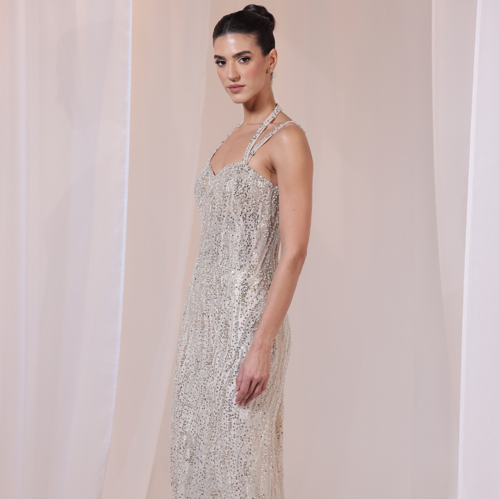 Shop online shimmering gown with delicate straps, intricate beadwork and sleek luminous silhouette, perfect for parties and special occasions.