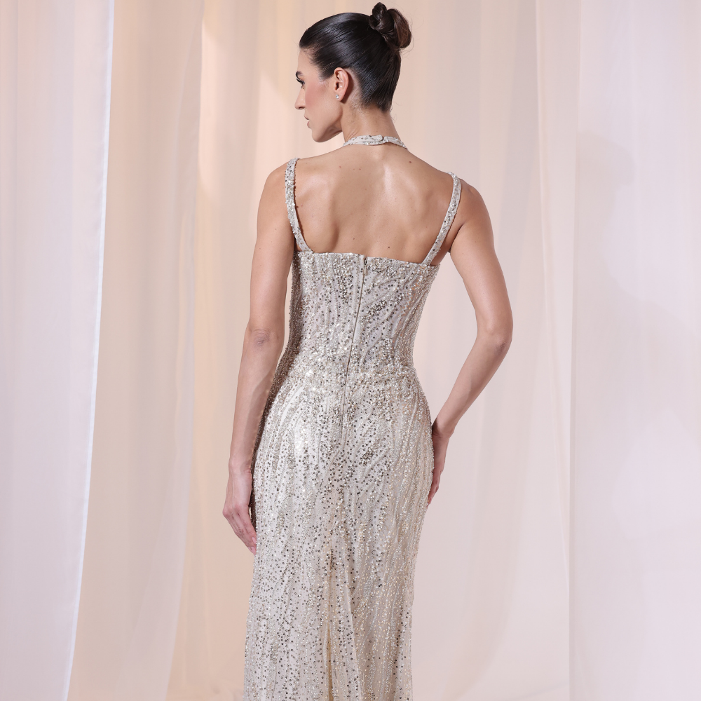 Shop online shimmering gown with delicate straps, intricate beadwork and sleek luminous silhouette, perfect for parties and special occasions.