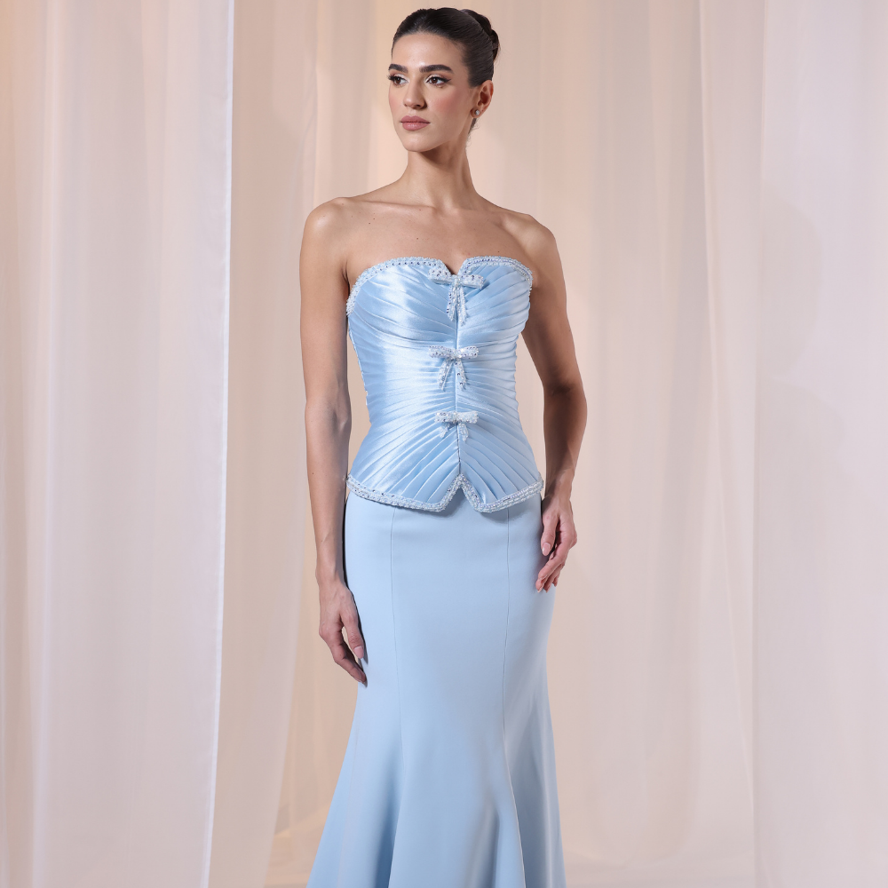 Shop online light blue gown with structured corset bodice, soft pleated details and sleek elegant silhouette, perfect for parties and special occasions.