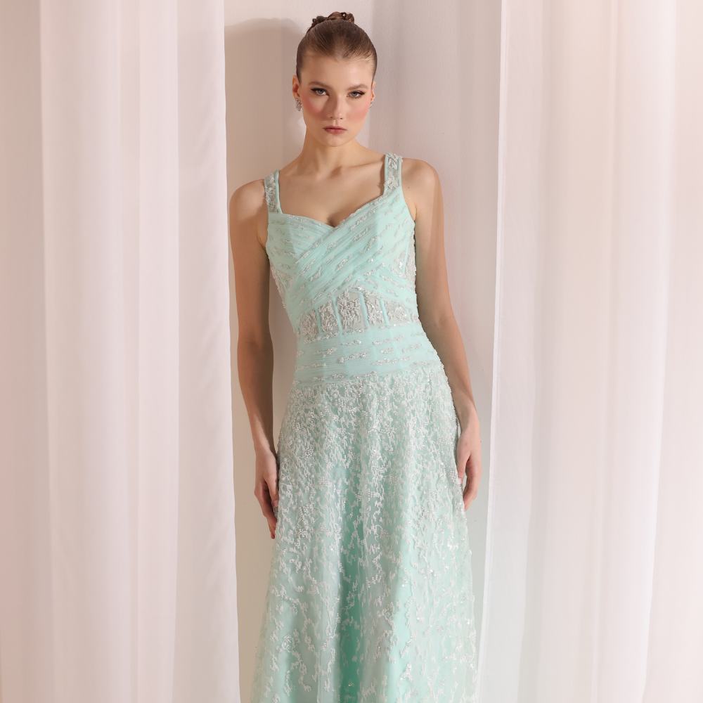 Shop online soft mint gown with structured pleated bodice, delicate shimmer details and flowing embellished skirt, perfect for parties and special occasions.