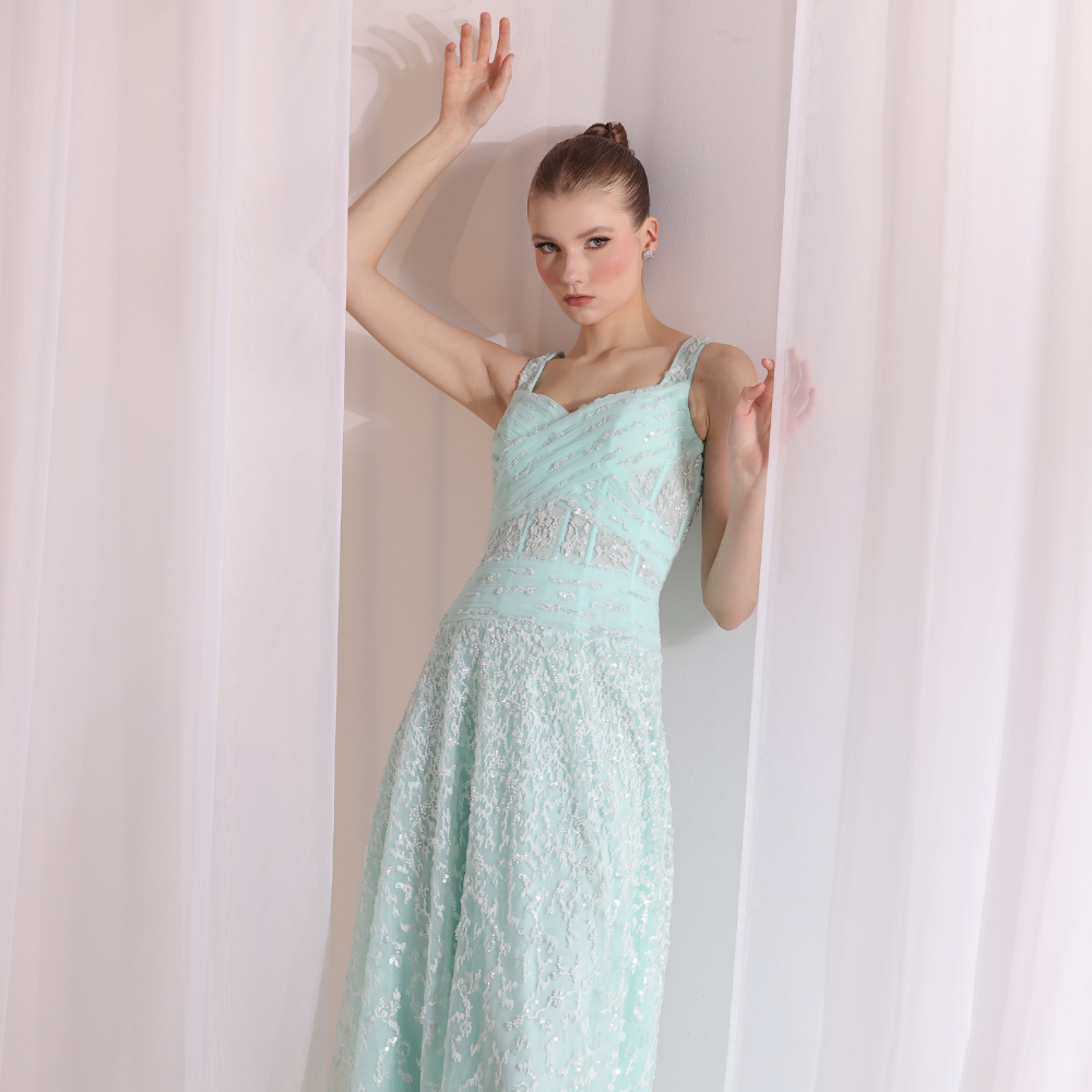 Shop online soft mint gown with structured pleated bodice, delicate shimmer details and flowing embellished skirt, perfect for parties and special occasions.