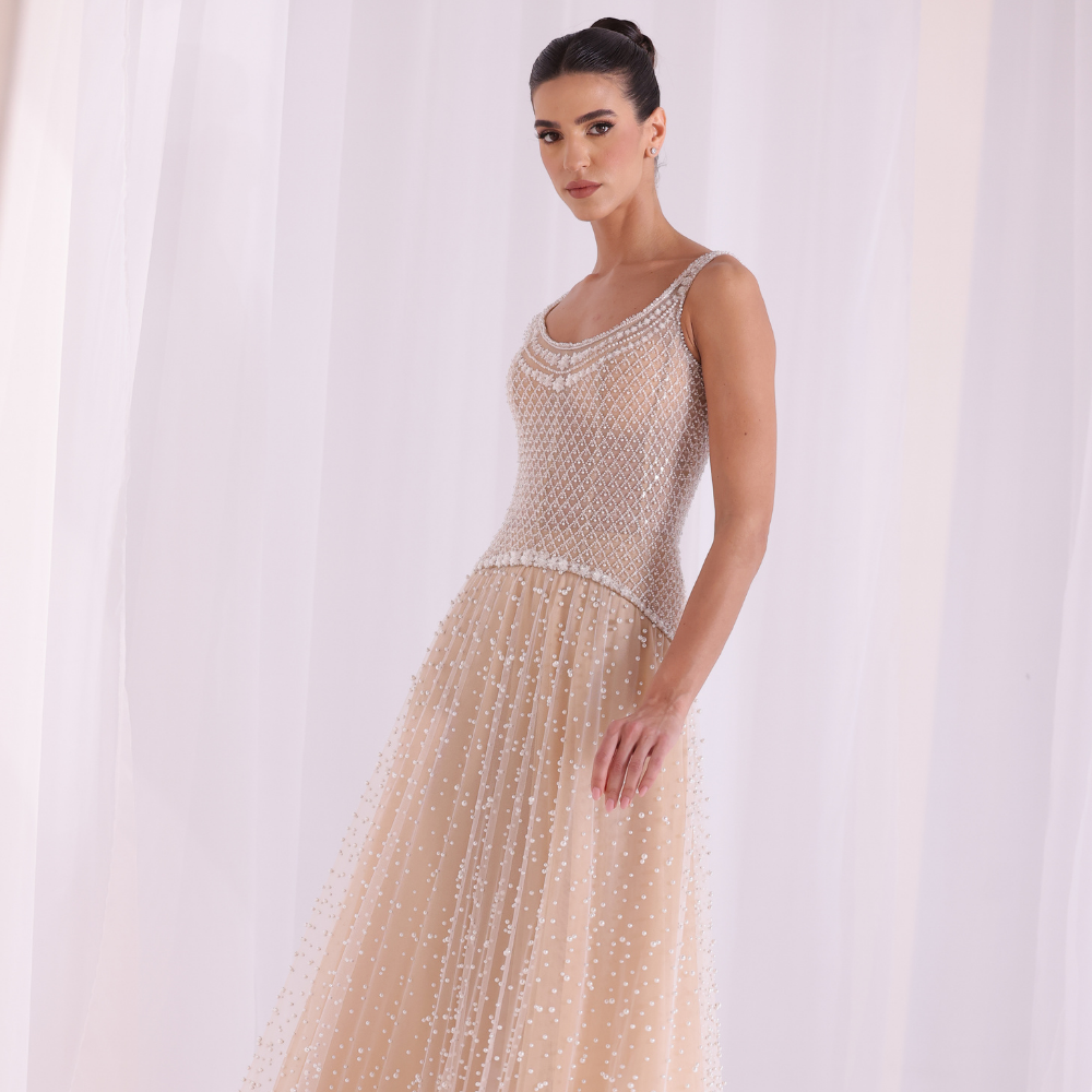 Shop online nude-toned gown with intricate beadwork, delicate textures and flowing embellished layers, perfect for parties and special occasions.