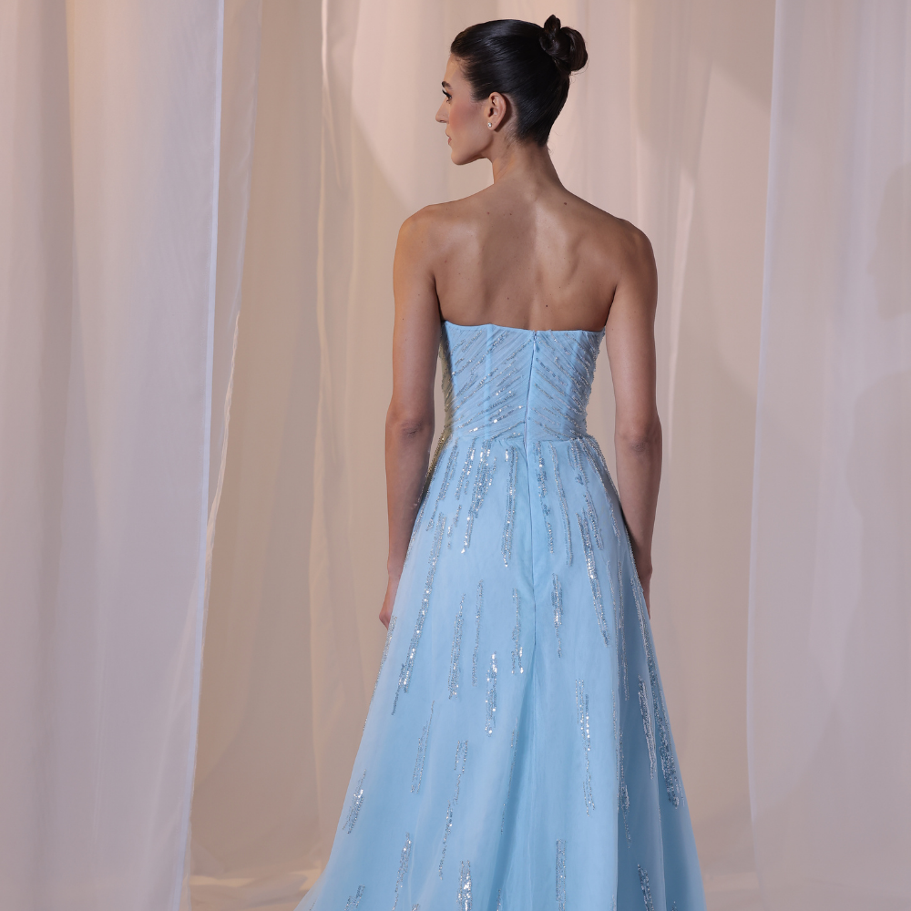 Shop online soft sky-blue gown with structured strapless bodice, shimmer details and flowing embellished skirt, perfect for parties and special occasions.