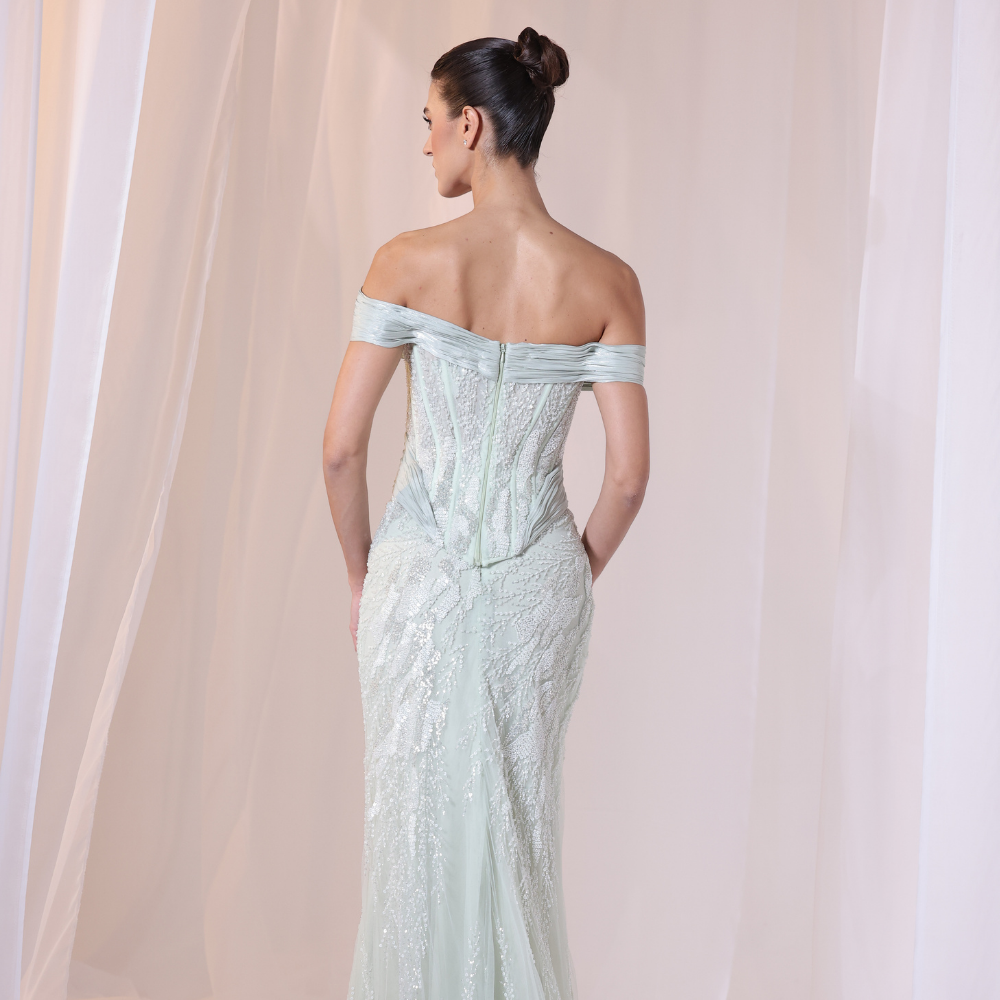 Shop online soft mint gown with embellished corset bodice, fitted silhouette and elegant off-shoulder draping, perfect for parties and special occasions.