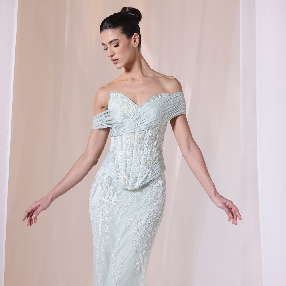 Shop online soft mint gown with embellished corset bodice, fitted silhouette and elegant off-shoulder draping, perfect for parties and special occasions.