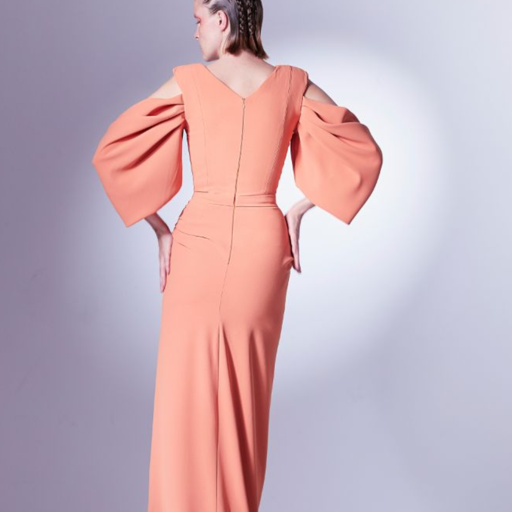 The V-neck and open shoulders give it a sense of modernity, while the draping is wrapped and gathered around the waistline.