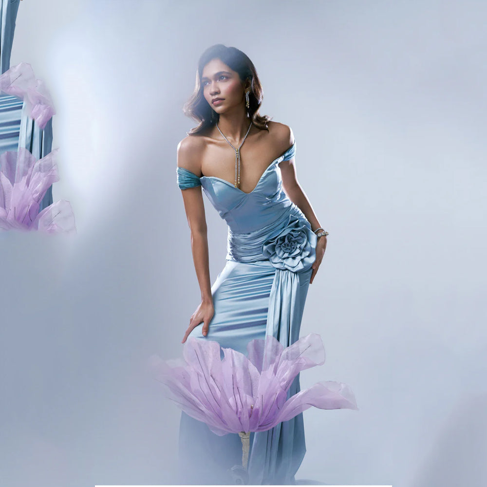Light blue off shoulder gown with sweetheart neck and ruched fit, perfect for events. Shop online from our exclusive collection of premium styles.