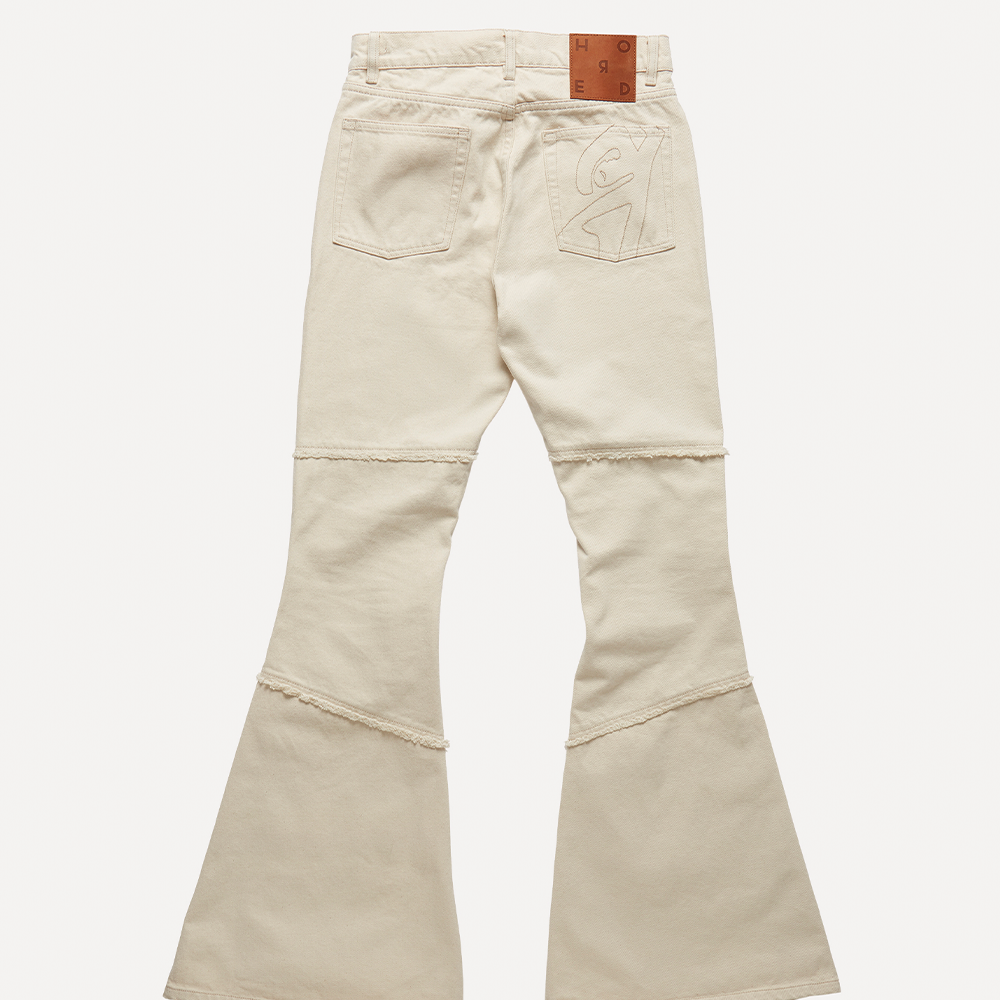 Cut for a slim fit with a flared hem in natural off-white organic 100% cotton mid-weight denim.