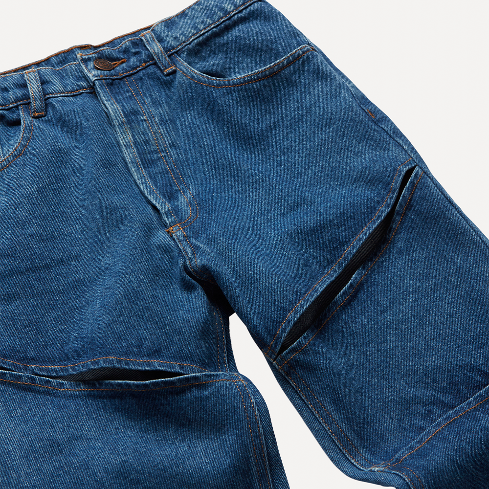 Dark blue mid-weight 100% cotton organic denim with linear cut-outs. Cut for a mid-rise, straight-leg fit with cropped length