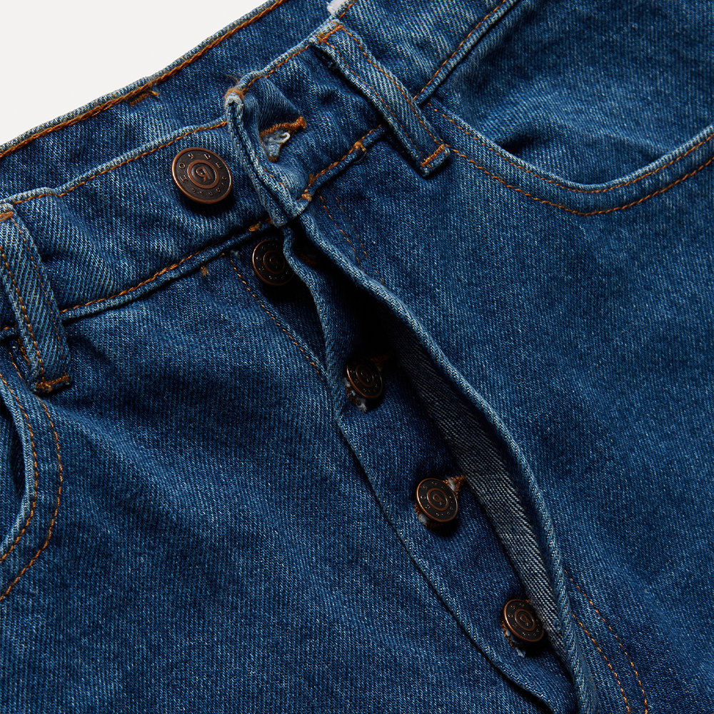 Dark blue mid-weight 100% cotton organic denim with linear cut-outs. Cut for a mid-rise, straight-leg fit with cropped length