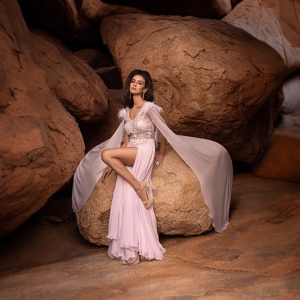 Aurora lights depicted in embroidery over bodice with wing drapes on shoulders and highh slit voluminous chiffon skirt.