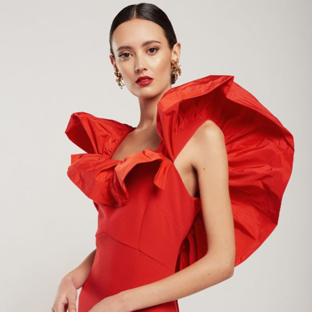 Long red crepe dress with a technical fabric ruffle. Perfect for an evening wedding & party wear. The crepe body will adjust to your body. Shop now!