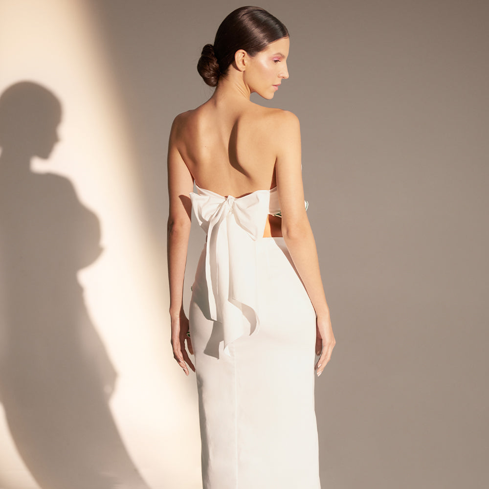 Midi skirt with front slit, vertical cascading ruffle with contrasting embroidery.