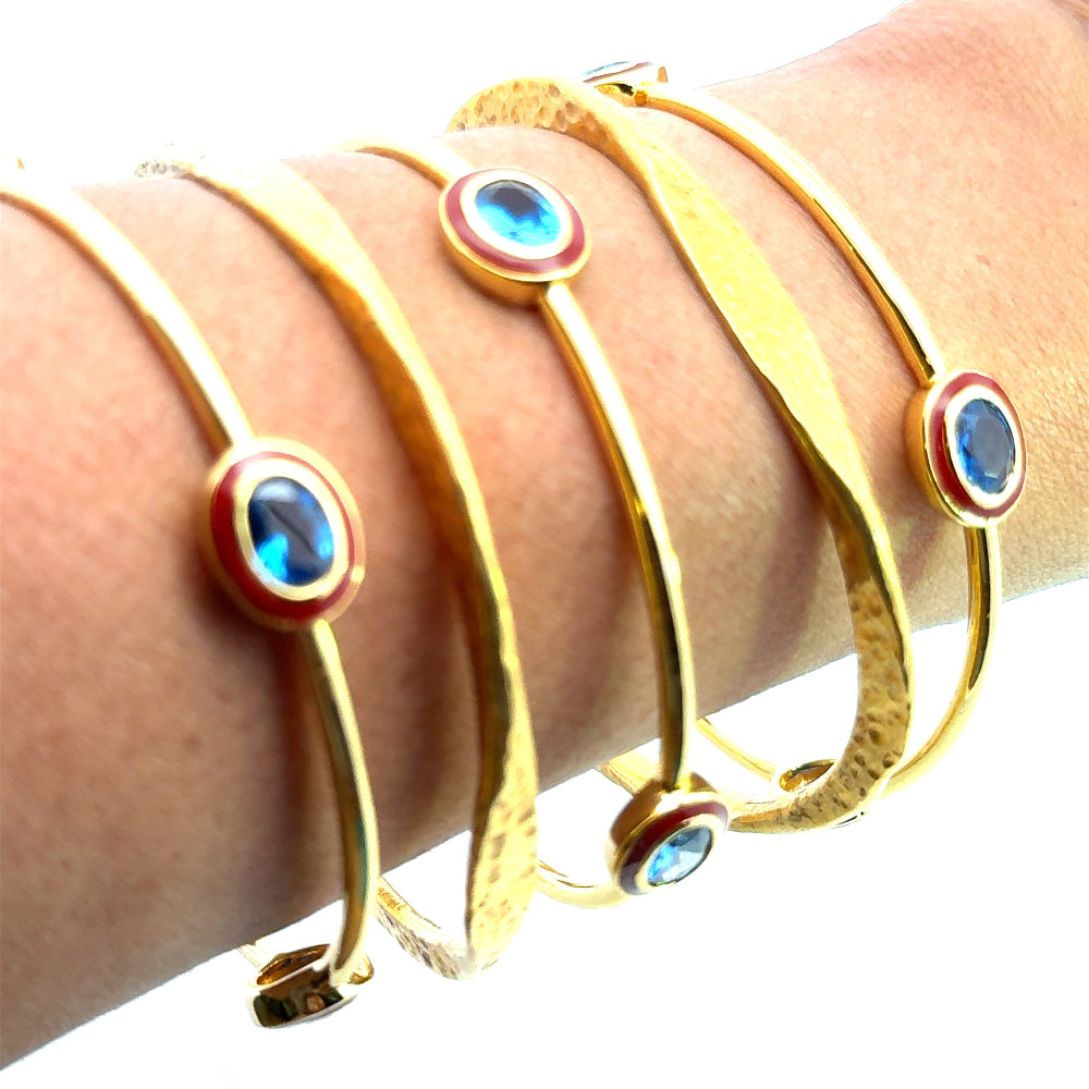 Bohemian 22K gold plated bangle with sparkling oval created Spinel and red enamel detailing. Perfect for stacking or statement styling. Shop premium jewelry online.