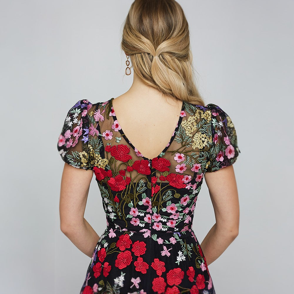 Cocktail dress is both elegant and whimsical. Colorful embroidery from the neckline down to the bottom of the skirt 