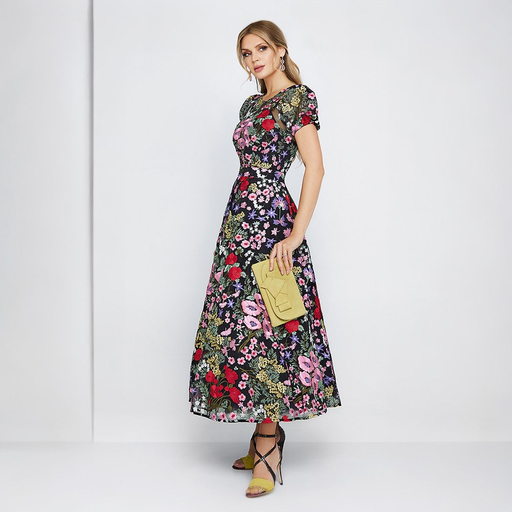 Cocktail dress is both elegant and whimsical. Colorful embroidery from the neckline down to the bottom of the skirt 