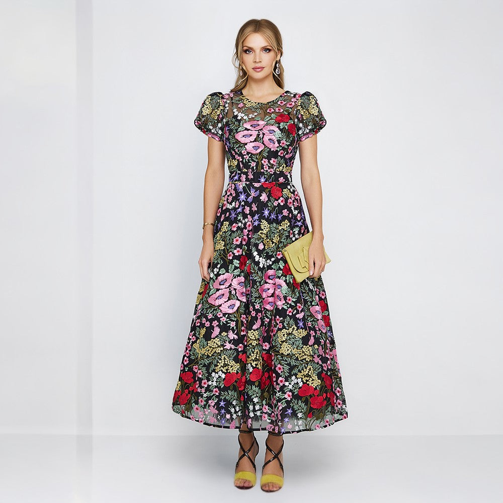 Cocktail dress is both elegant and whimsical. Colorful embroidery from the neckline down to the bottom of the skirt 