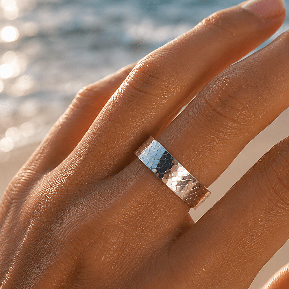 Discover the Mermaid Band Sterling Silver Ring at The Luxe Maison, featuring a wide S925 sterling silver band with intricate fish scale-inspired detailing and a polished finish. With its adjustable open-back design and ocean-inspired elegance, this bold statement ring adds a touch of coastal charm to everyday looks and layered silver jewelry.