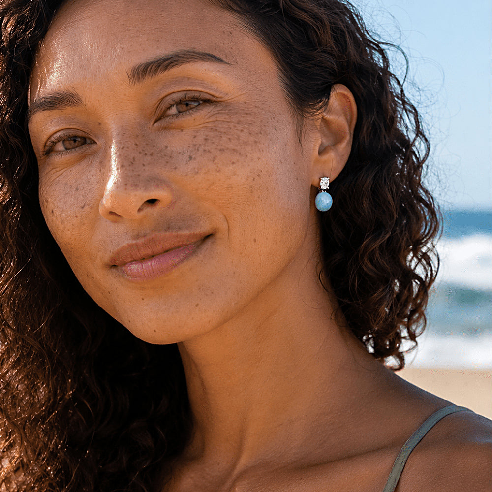 Discover the Mermaid's Tear Larimar Stud Earrings at The Luxe Maison, featuring luminous natural larimar stones paired with sparkling cubic zirconia. Inspired by the turquoise hues of the Caribbean Sea, these elegant earrings bring a refreshing touch of coastal beauty to everyday outfits and special occasions.