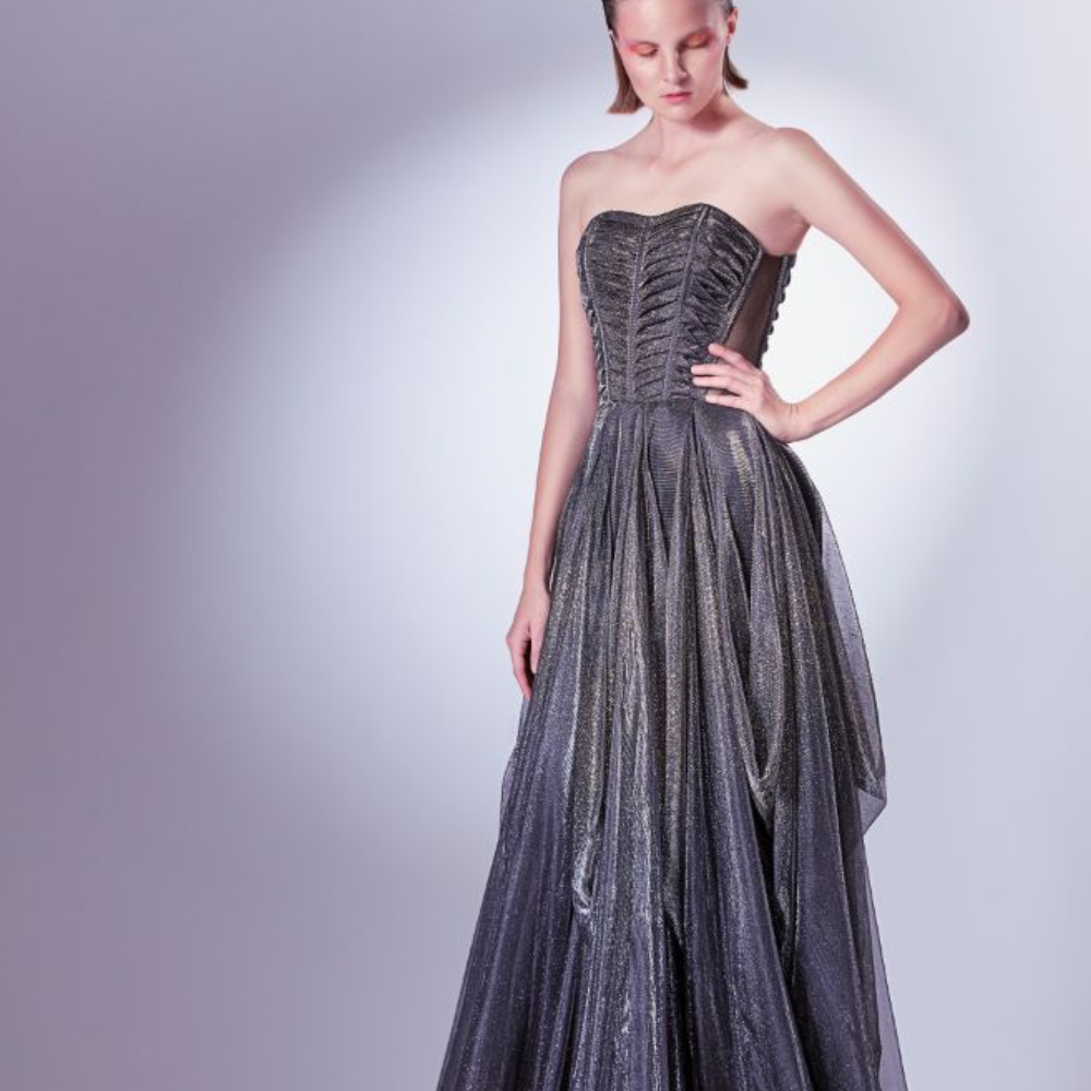 This dress radiates with every movement as gold and silver shimmers sparkle from the black tulle jersey base.