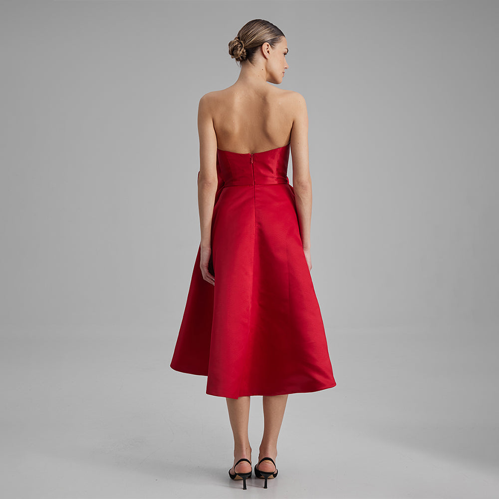 Explore our Red Midi Dress with a removable flower bow. Elevate your wardrobe with this timeless piece. Shop designer dresses for women. Shop now!