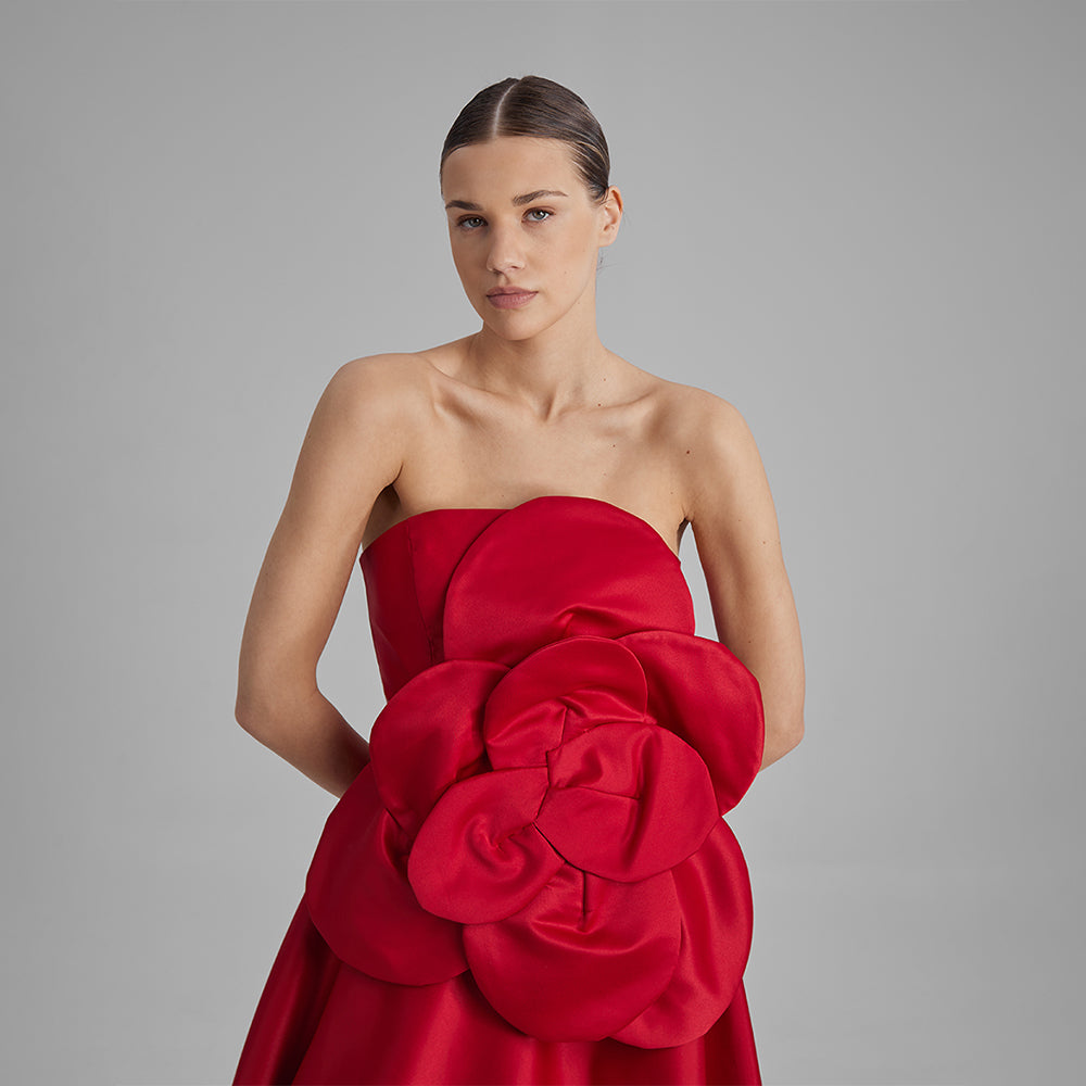 Explore our Red Midi Dress with a removable flower bow. Elevate your wardrobe with this timeless piece. Shop designer dresses for women. Shop now!