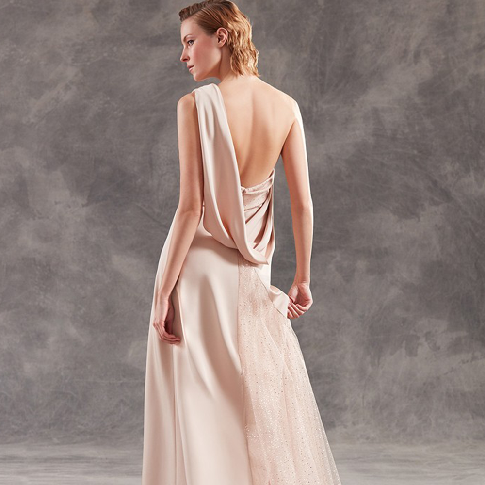 One shoulder gown in silk crepe with tulle details and drapings.