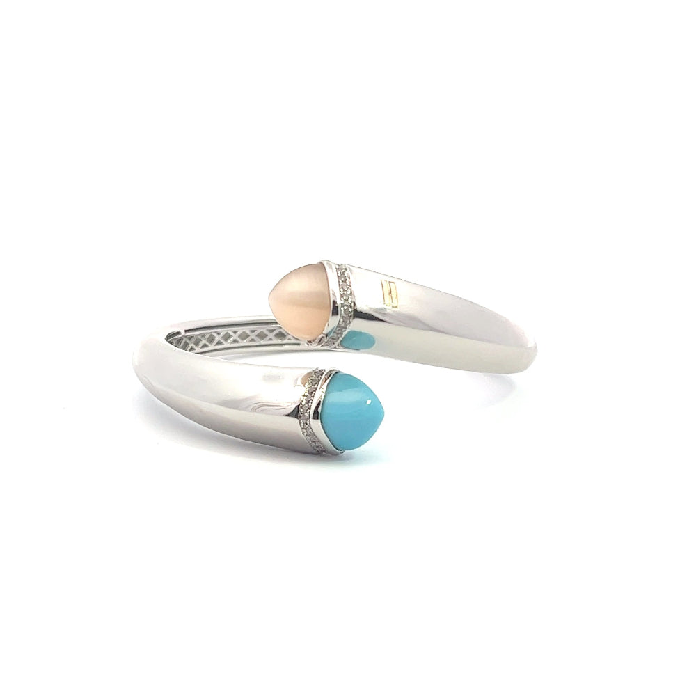 Elegant rhodium plated cuff bracelet with colored pyramidal crystals and sparkling pavé cubic zirconia accents. Perfect for modern luxe styling. Shop premium jewelry online.