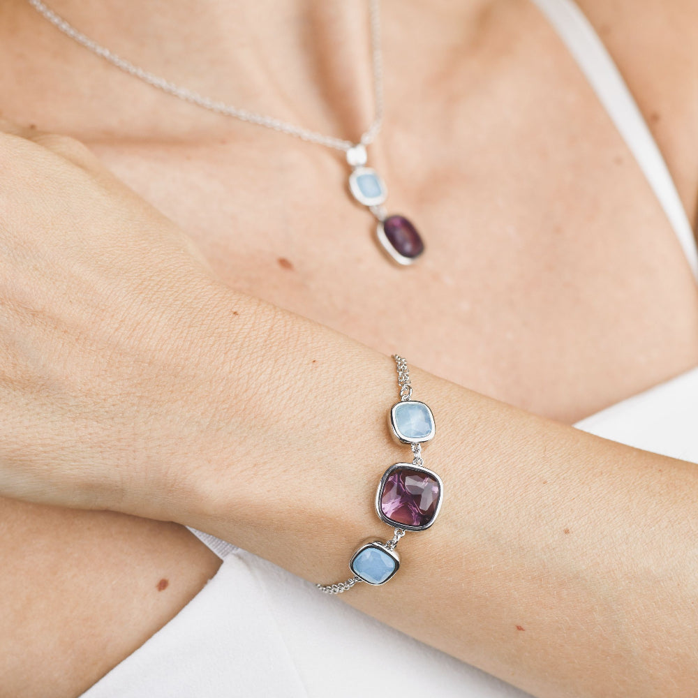 Rhodium-plated bronze bracelet featuring a large purple amethyst crystal paired with soft milky blue aquamarine accents for a contemporary finish. Shop premium jewelry online.