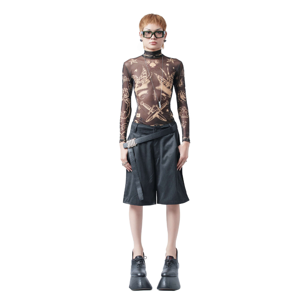 A long-sleeved top made from 100% polyester fabric. The design features a collection of small and medium-sized tattoos.