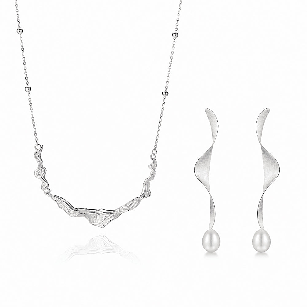 Discover the Moontide Sterling Silver Necklace & Earrings Jewelry Set at The Luxe Maison, featuring sculptural wave-inspired designs in S925 sterling silver for an elegant, timeless look inspired by the sea.