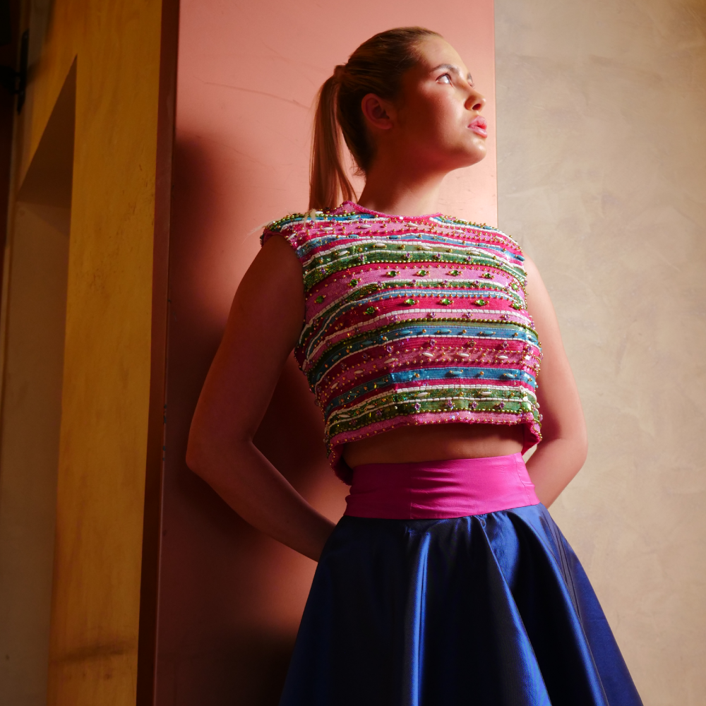 Vibrant multicolor embroidered crop top pairs elegantly with a silk navy blue taffeta skirt.